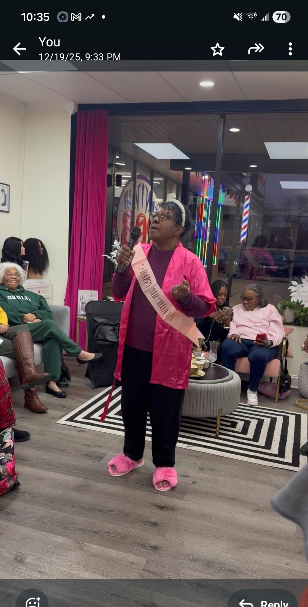 Birthday spa party celebration — birthday honoree with sash and microphone