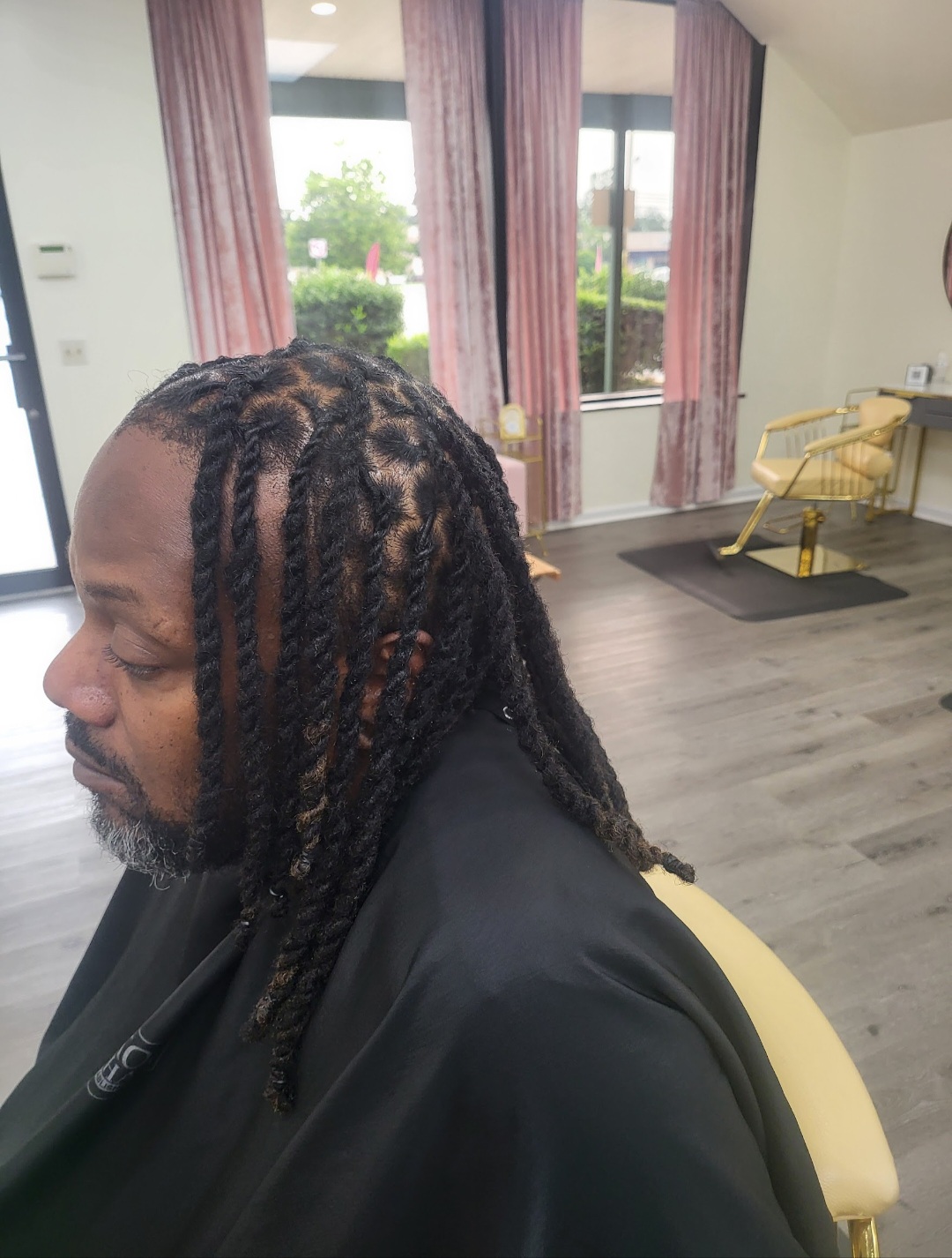 Men's two-strand twist locs in salon chair — men's natural hair services Delaware