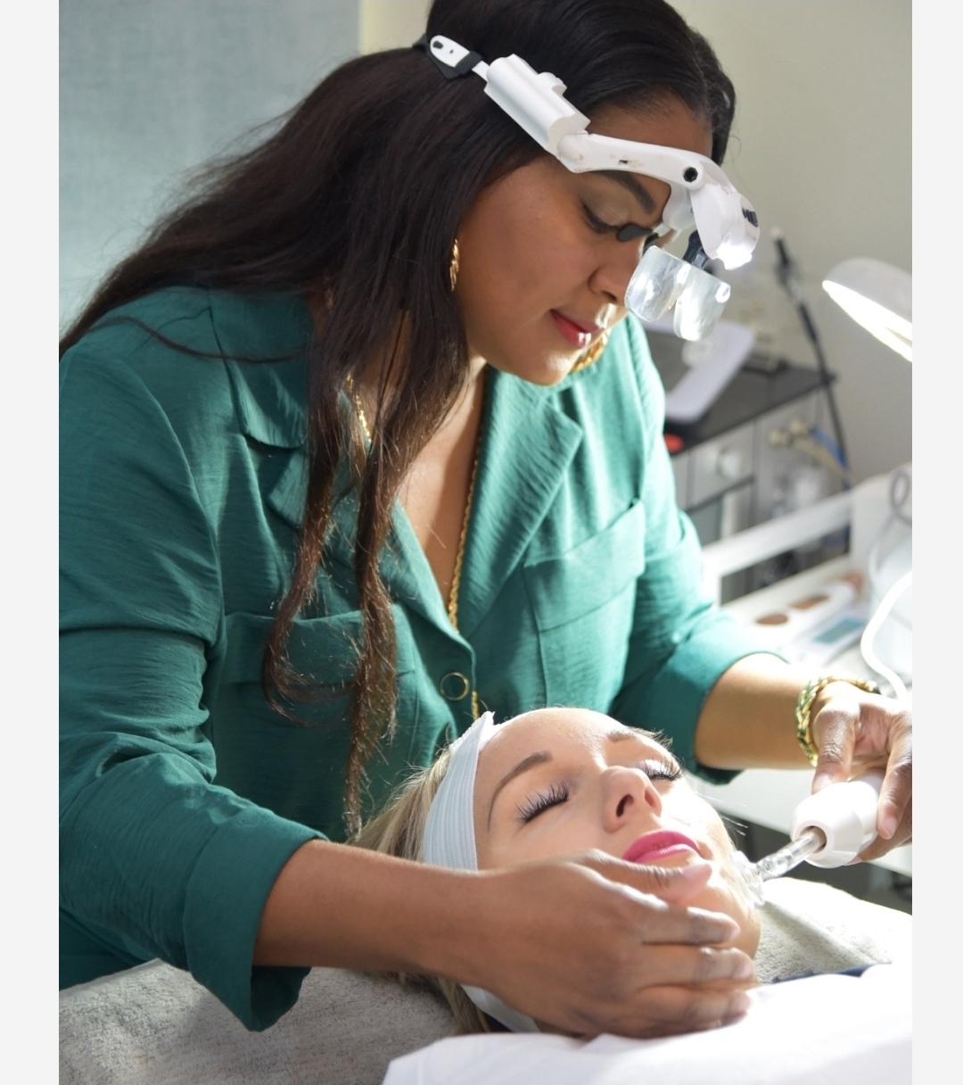 Facials — Esthetician with magnifying headset performing facial on client