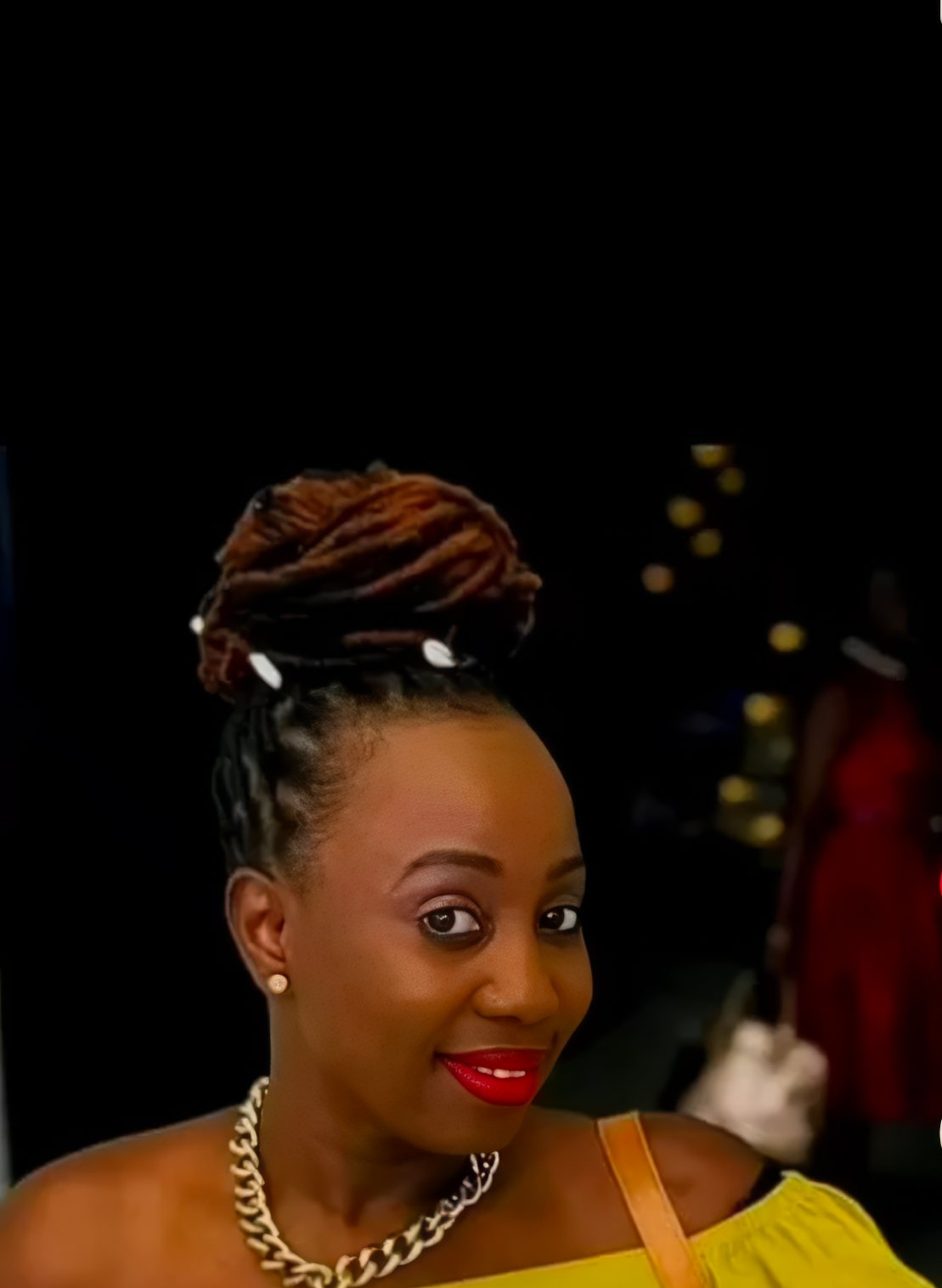 Loc retwist near me — woman with stunning loc updo in yellow top at dreadlock salon Sinkor Beauty Salon Delaware